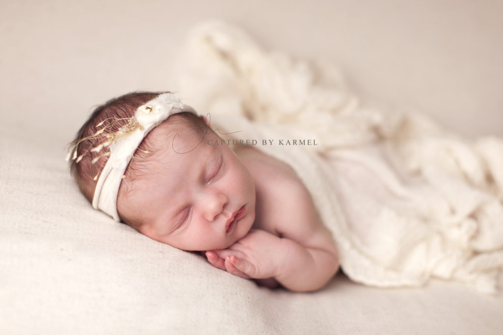 newborn girl photo on white blanket